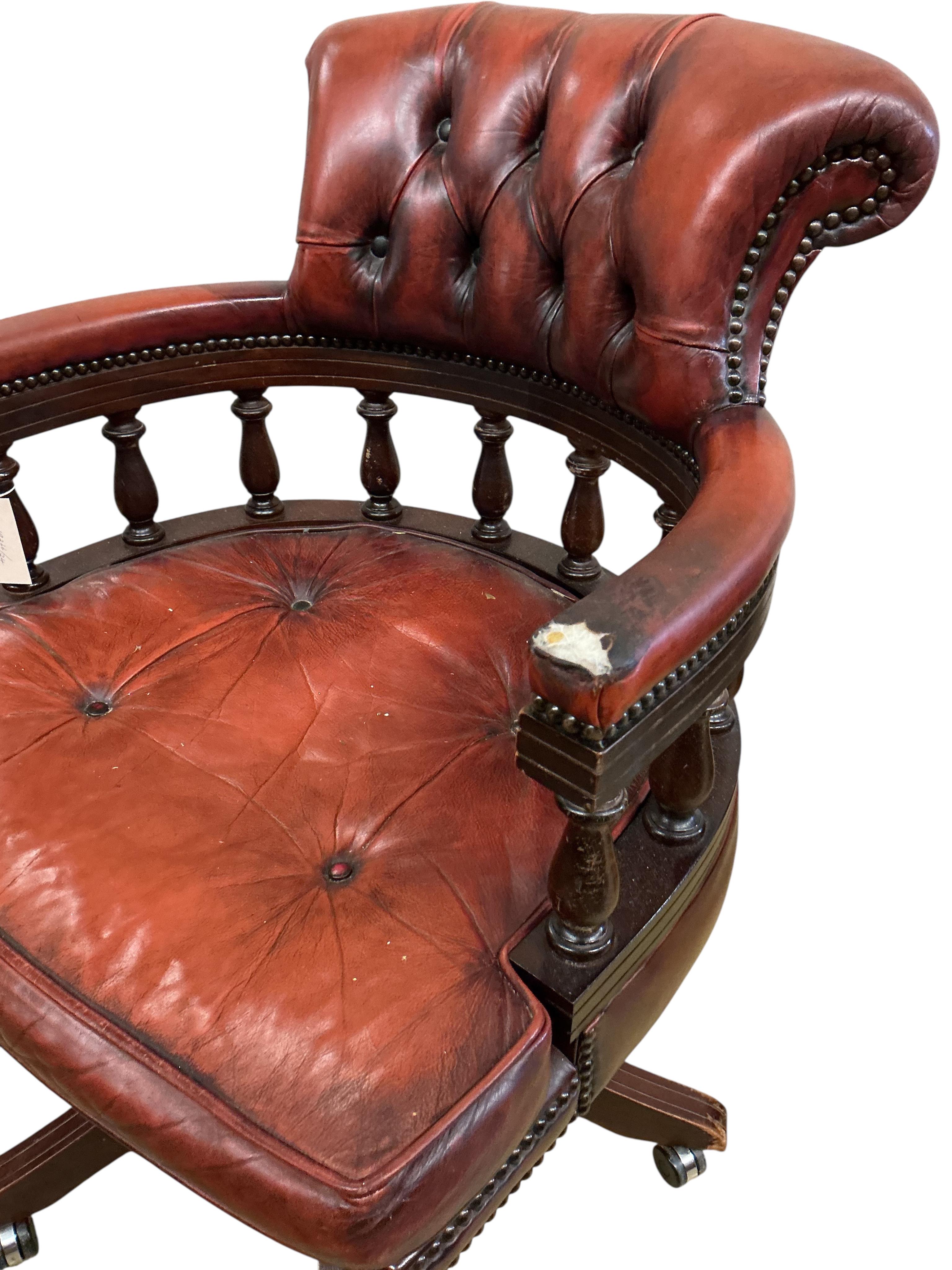 A reproduction buttoned burgundy leather swivel desk chair, width 62cm, depth 56cm, height 89cm